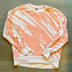 Sweaty Betty Essentials creamsicle orange sweatshirt.